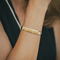 Bracelet Hermès - Bracelet jonc demi-ouvert en or jaune et blanc 18k avec diamants 58 Facettes 50239