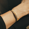 Bracelet Hermès - Bracelet jonc demi-ouvert en or jaune et blanc 18k avec diamants 58 Facettes 50239