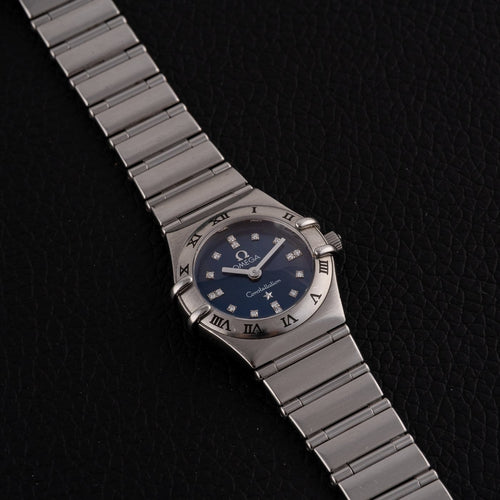 Montre Omega Constellation - Montre femme à quartz, acier, cadran bleu, réf. 1563.86.00 58 Facettes TOT-12001