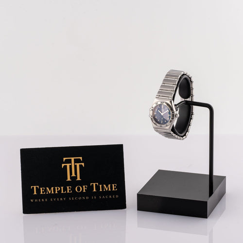 Montre Omega Constellation - Montre femme à quartz, acier, cadran bleu, réf. 1563.86.00 58 Facettes TOT-12001