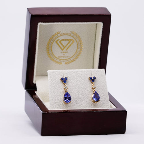 Boucles d'oreilles Boucles d’oreilles pendantes articulées en or jaune 14 carats, tanzanites, saphirs et diamants 58 Facettes E0067