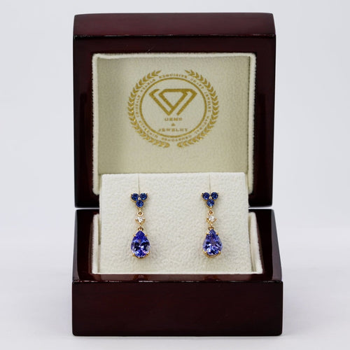 Boucles d'oreilles Boucles d’oreilles pendantes articulées en or jaune 14 carats, tanzanites, saphirs et diamants 58 Facettes E0067