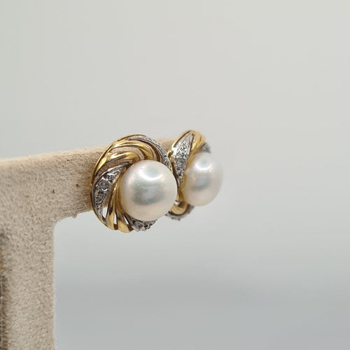 Boucles d'oreilles Boucles d’oreilles en or jaune et blanc avec perle 58 Facettes #5034