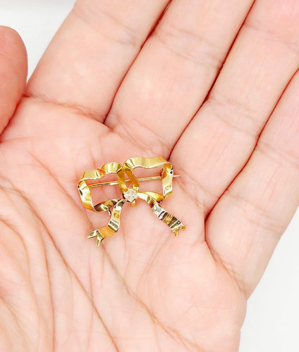 Broche Broche nœud en or 18k avec diamant taille ancienne, vers 1920 58 Facettes A08093