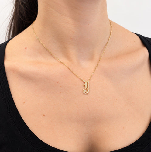 https://18carats.fr/wp-content/uploads/2026/10/38013-39524-Collier-en-or-jaune-pendentif-J-pave-de-diamants.jpeg