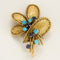 Broche Broche Mauboussin en or jaune, turquoises et saphirs 58 Facettes 58FC115