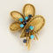 Broche Broche Mauboussin en or jaune, turquoises et saphirs 58 Facettes MAN2079