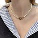 Necklace Dinh Van “Menottes R15” pearl necklace in yellow gold. 58 Facettes 30101