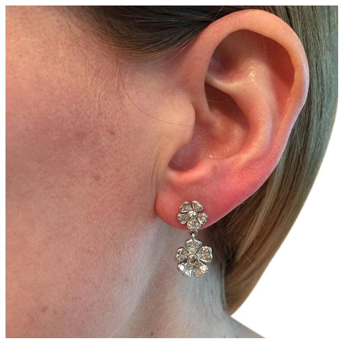Pair of pendant earrings with flower motif in white gold, diamonds.