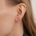 Djula earrings - White Gold Cross hoop earrings with diamonds 58 Facettes