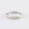 Bague Demi alliance en or gris sertie clos, diamants 58 Facettes 750
