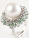Ring 52 Ring in white gold, pearl, diamonds, and green tourmalines 58 Facettes