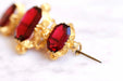Brooch Old brooch in pomponne and red stones 58 Facettes