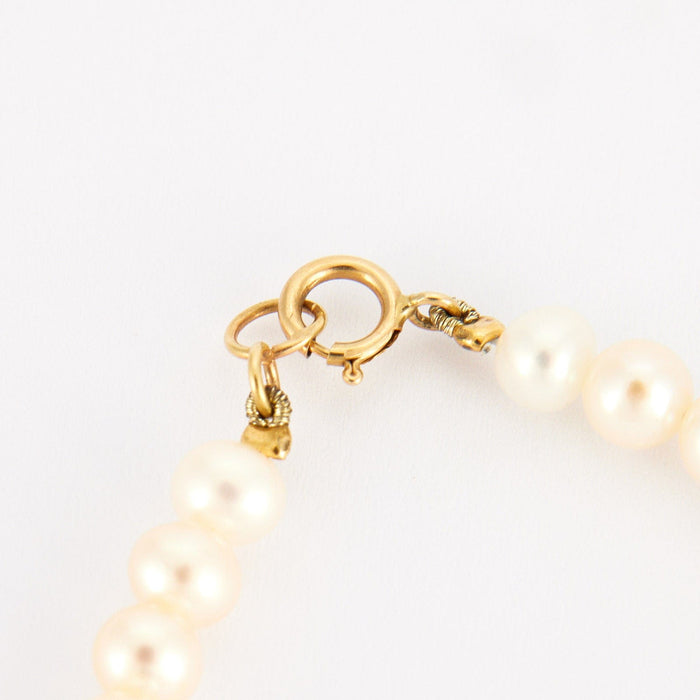 Bracelet Bracelet perles blanches et or jaune 58 Facettes P4L8