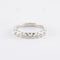 Bague Demi alliance en or gris sertie clos, diamants 58 Facettes 750